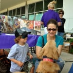lady and child with service dog petting