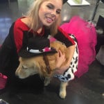 Woman in cat costume hugs Mysti, mobility service dog, in cowgirl costume