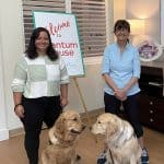 Two women and dogs at Quantum House welcome event.