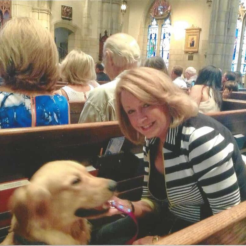 Bev Broberg, Director, Genesis Assistance Dogs, Inc. and Wally attend church.